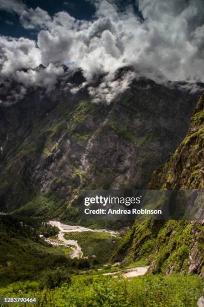 rugged mountains and snow capped peaks through cloud on the road to sri hemkund sahib sacred pilgrimage site in the valley of flowers in the himalayas - valley of flowers uttarakhand stock-fotos und bilder