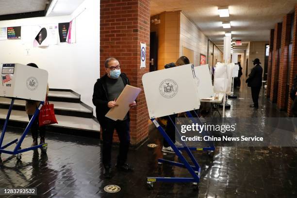 Chinese voters cast ballots at a polling station for the 2020 U.S. Presidential election on November 3, 2020 in Manhattan, New York.
