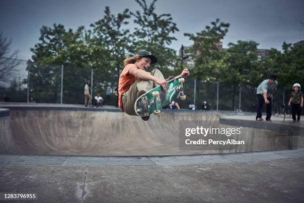 skateboarder grabbing board in the air - adrenaline park stock pictures, royalty-free photos & images