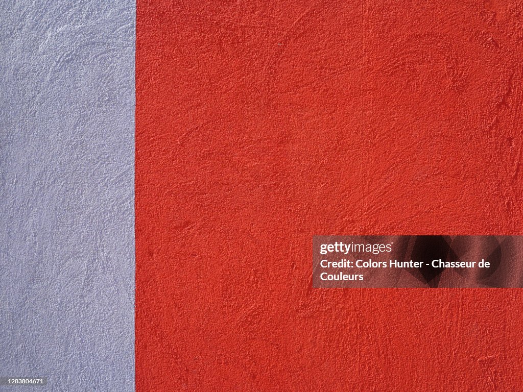 Concrete wall painted in red and gray with rough texture in Porto
