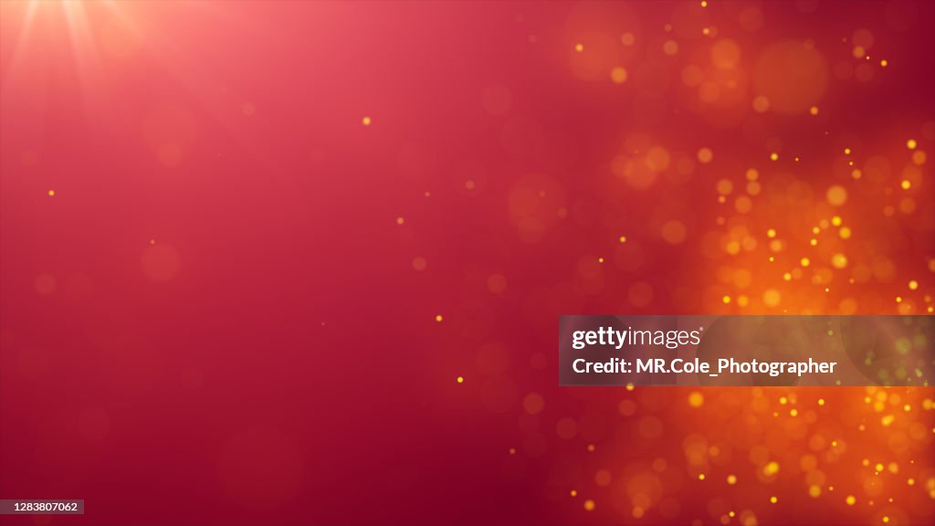 Abstract Background of De-focused Gold Colored Particles on Red Background with Lens flare