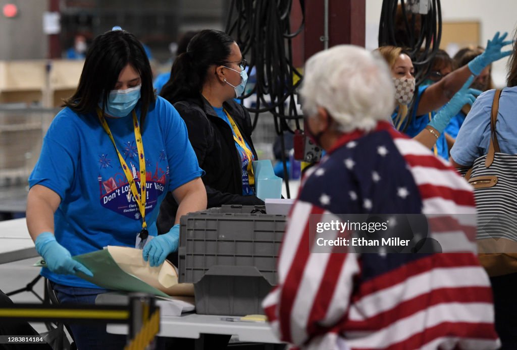 Election Officials Workers process polling place equipment and materials at the Clark ...