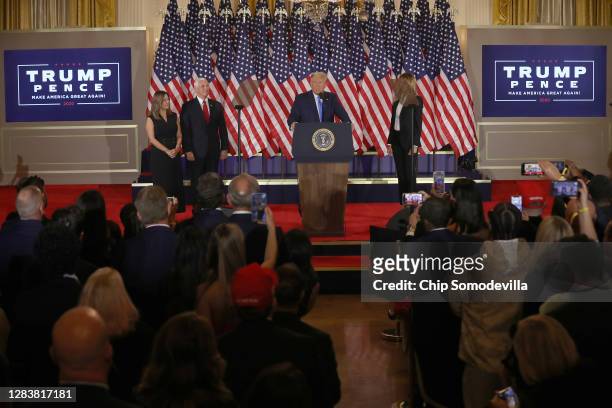 President Donald Trump speaks on election night in the East Room of the White House as First Lady Melania Trump, Vice President Mike Pence and Karen...