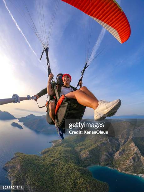 paragliding piloot met klant. tandem paragliding. - paragliding stockfoto's en -beelden