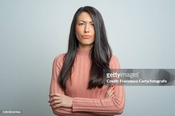 young frowning lady - suspicion stock pictures, royalty-free photos & images