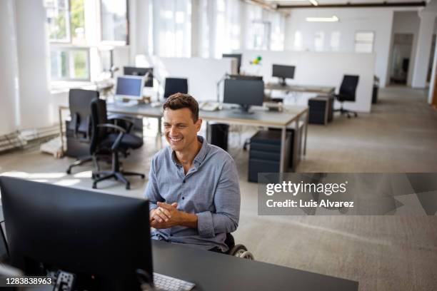 entrepreneur having a web conference at office desk - empty office one person stock pictures, royalty-free photos & images