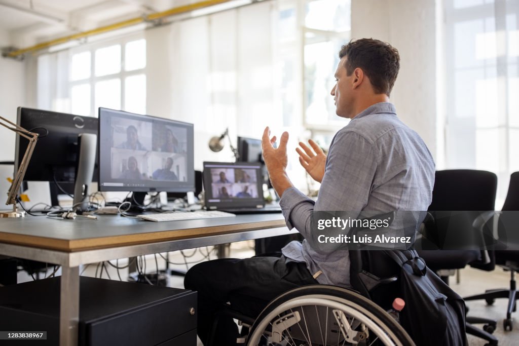 Businessman with disability having a video call at his desk