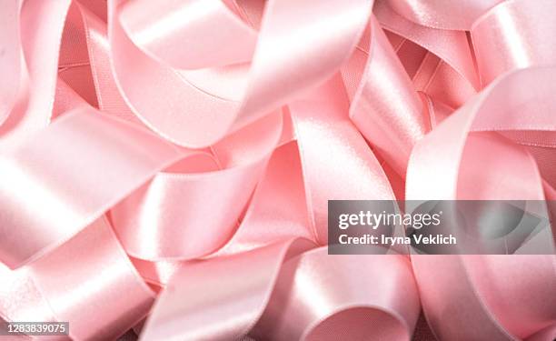 holiday background made from pink satin ribbon. - satin ribbon stock pictures, royalty-free photos & images