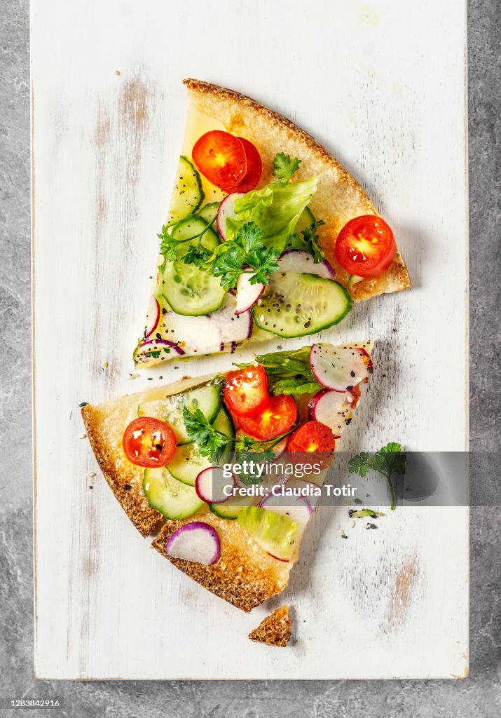 Slices of vegetarian and gluten-free pizza on white background