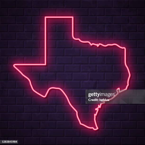 texas map - glowing neon sign on brick wall background - texas shape stock illustrations