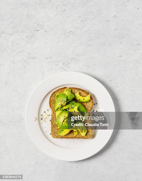 toast with avocado on white background - rostbröd bildbanksfoton och bilder