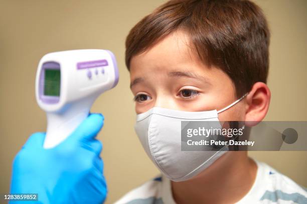 In this photo illustration, a young child having his temperature taken during an NHS Coronavirus test Photographed by Peter Dazeley, Kingston On...