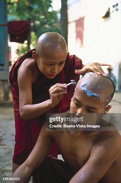 mandalay, novice monk shaving other's head - boeddhisme stockfoto's en -beelden