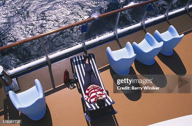 female passenger in deck chair, cruise ship - cruise deck stock pictures, royalty-free photos & images