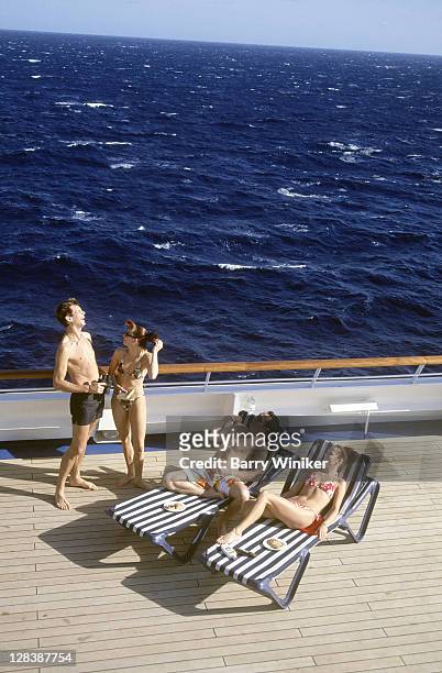couples laughing on deck of cruise ship - cruise deck stock pictures, royalty-free photos & images