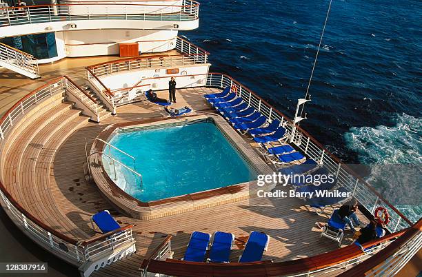 people on deck of cruise ship late afternoon - schiffsdeck stock-fotos und bilder