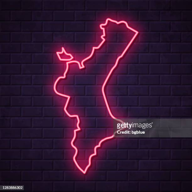 valencian community map - glowing neon sign on brick wall background - comunidad autonoma de valencia stock illustrations