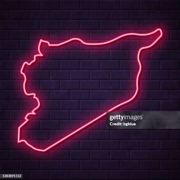 syria map - glowing neon sign on brick wall background - damaskus stock illustrations