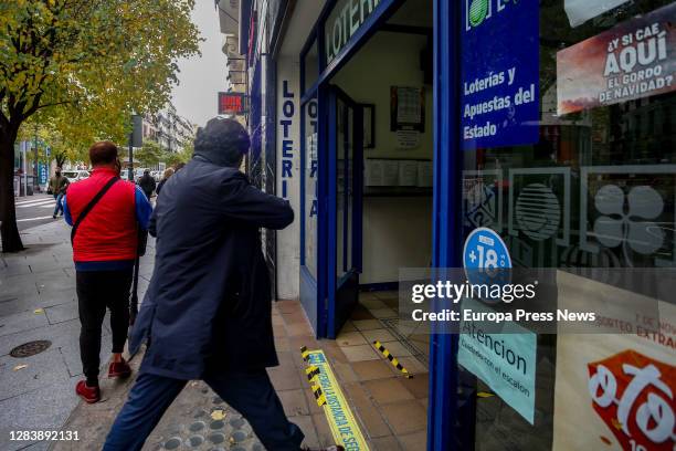 Person enters through the door of the La Pajarita administration where tickets for the Special Drawing of the Christmas Lottery 2020 are sold, on...