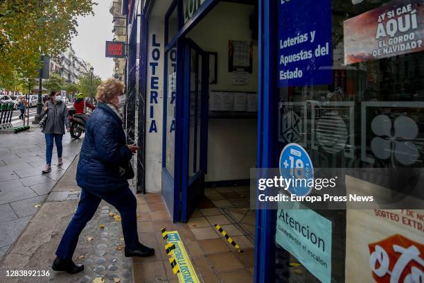 Person enters through the door of the La Pajarita administration where tickets for the Special Drawing of the Christmas Lottery 2020 are sold, on...