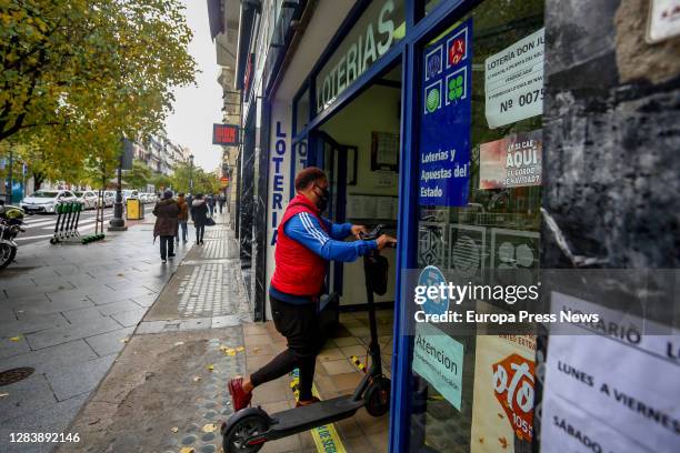 Person enters through the door of the La Pajarita administration where tickets for the Special Drawing of the Christmas Lottery 2020 are sold, on...