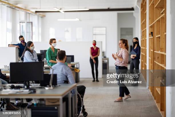 business team having a meeting post-pandemic reopen - social distancing stock pictures, royalty-free photos & images