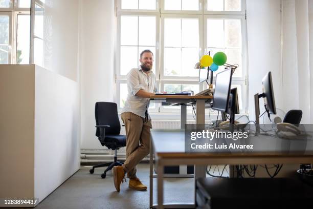 businessman standing at ergonomic desk in office - ergonomic keyboard stock pictures, royalty-free photos & images