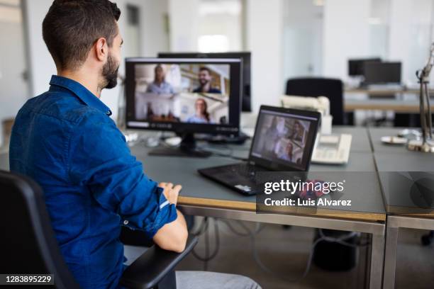 businessman video conferencing with team - man office chair stock pictures, royalty-free photos & images