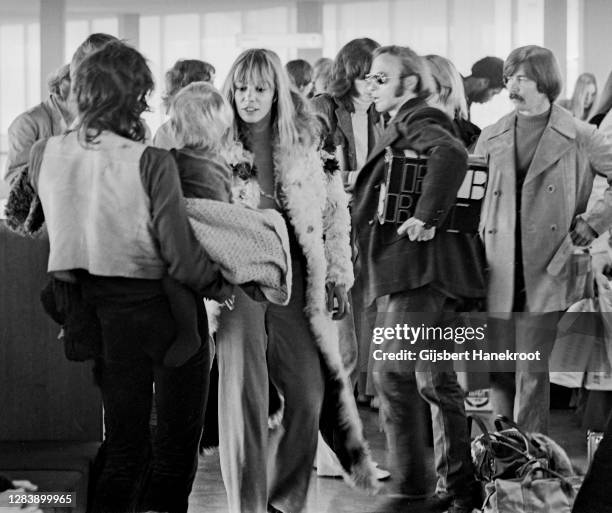 Anita Pallenberg with Keith Richards of The Rolling Stones and Steven Stills at Schiphol Airport, Netherlands, returning home after the last date of...