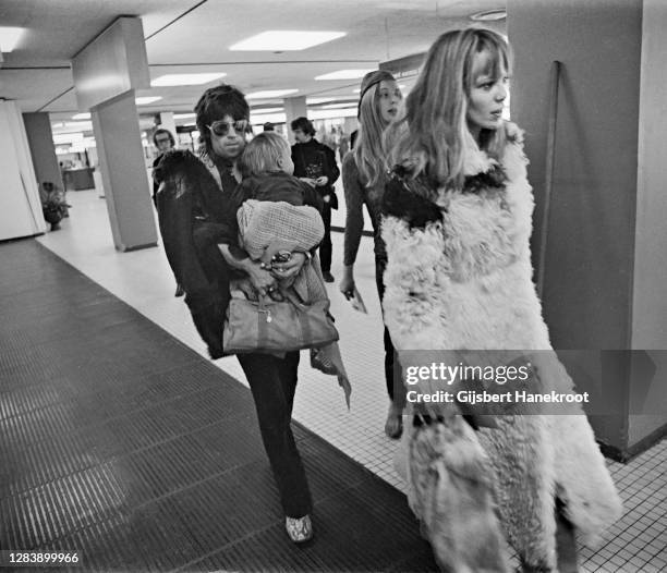 Anita Pallenberg with Keith Richards of The Rolling Stones holding their son Marlon at Schiphol Airport, Netherlands, returning home after the last...