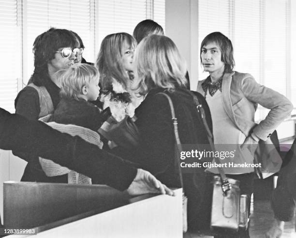 Keith Richards and Charlie Watts of The Rolling Stones with Anita Pallenberg at Schiphol Airport, Netherlands, returning home after the last date of...