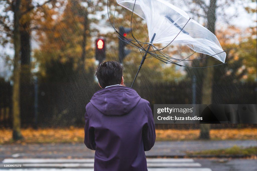 Man with umbrella on a stormy day