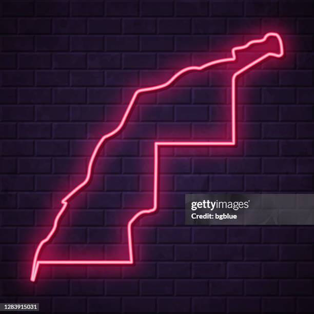 western sahara map - glowing neon sign on brick wall background - led light wall stock illustrations