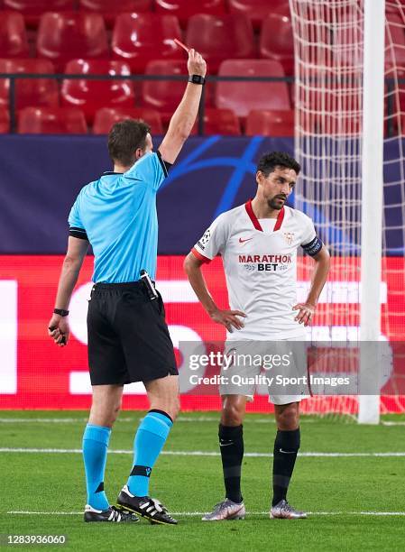 Jesus Navas of Sevilla FC is shown a red card by match referee Felix Brych during the UEFA Champions League Group E stage match between FC Sevilla...