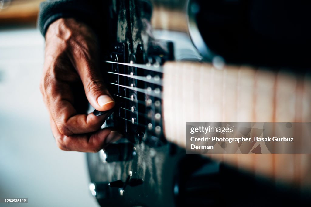 Close-up of a man playing guitar