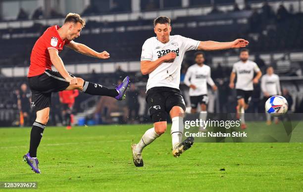 Tom Carroll of Queens Park Rangers shoots during the Sky Bet Championship match between Derby County and Queens Park Rangers at Pride Park Stadium on...