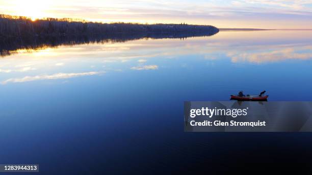 aerial of a man & dog in a canoe on a calm lake - canada indigenous landscape stock pictures, royalty-free photos & images