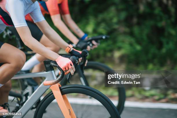 side view hands of 2 asian chinese woman road cyclist cycling in rural area in the morning - cycling team stock pictures, royalty-free photos & images