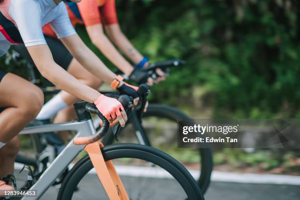 side view hands of 2 asian chinese woman road cyclist cycling in rural area in the morning - sports race bicycle stock pictures, royalty-free photos & images