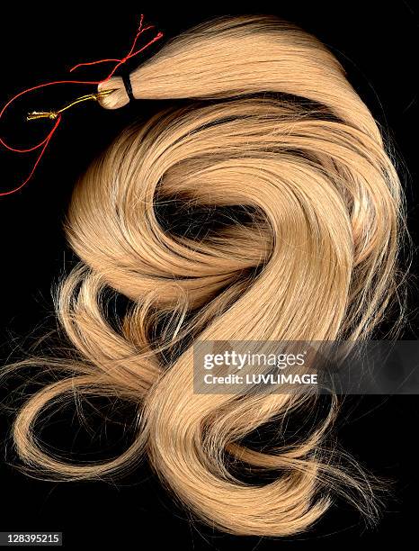 a lock of blonde synthetic hair - hair extensions stock pictures, royalty-free photos & images