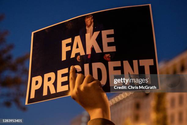 Man holds a sign in Black Lives Matter plaza during a rally outside the White House on November 4, 2020 in Washington, DC. The nation is awaiting the...