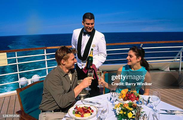 couple eating dinner on deck of cruise ship - dinner boat imagens e fotografias de stock