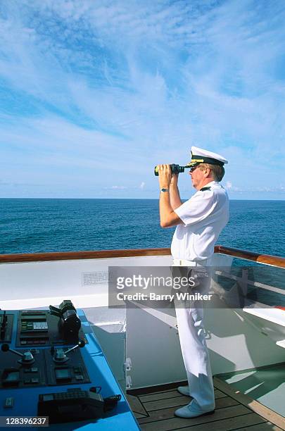 captain w/ binoculars on bridge of cruise ship - team captain stock pictures, royalty-free photos & images