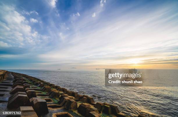 seascape at sunrise - dyke stockfoto's en -beelden