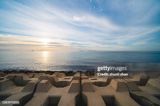 seascape at sunrise - dyke stockfoto's en -beelden