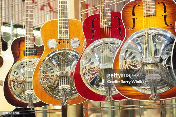 showcase displaying dobro resonating guitars - nashville stock-fotos und bilder