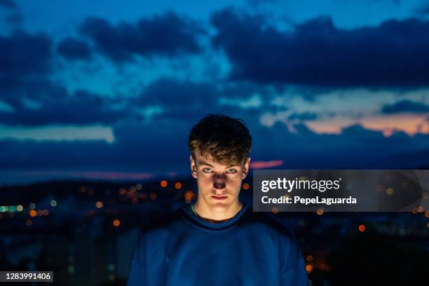 young man with evening city views - spain teen face imagens e fotografias de stock