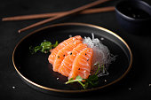 slices of fresh salmon with radish and soy sauce
