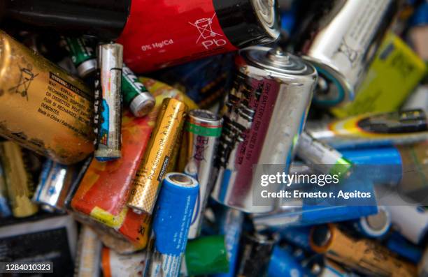 a bunch of used batteries of different sizes - alkaline stock pictures, royalty-free photos & images