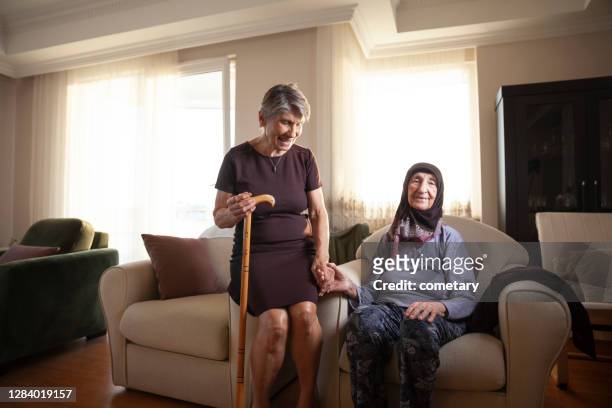 senior old woman senior adult sitting armchair - grandma cane stock pictures, royalty-free photos & images